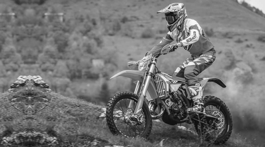 Piloto conduciendo una Beta 2T 200 en terreno montañoso.